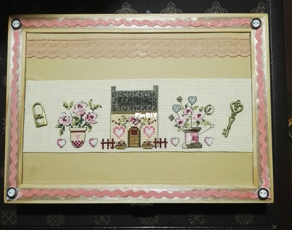 wooden box decorated with cross stitch pattern