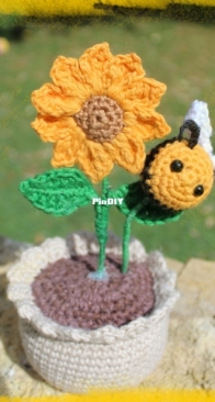 Sunflower in its pot and bee