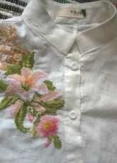 white lily on white blouse