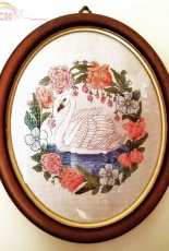 Swan in a frame of flowers