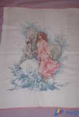 The girl with a horse in the waves.