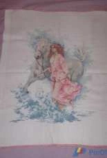 The girl with a horse in the waves.